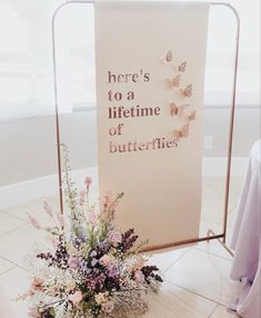 there is a sign that says here's to a lifetime of butterflies on it