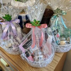 two baskets filled with chocolates and candies sitting on a wooden table next to each other