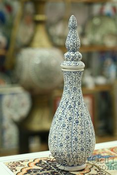 a blue and white vase sitting on top of a table