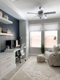 a living room with white furniture and gray walls