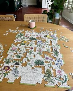 a wooden table topped with puzzle pieces covered in flowers