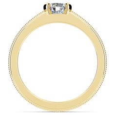 a yellow gold engagement ring with a single diamond in the center and beading around the band