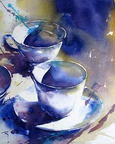 three cups and saucers on a plate with watercolor paint splashing around them