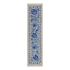 a blue and white runner rug with flowers on the bottom, in an ornate design