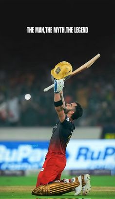 a man holding a cricket bat on top of a field