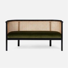 a black and green couch with wicker back