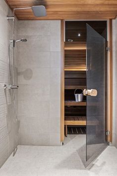 a walk in shower sitting next to a wooden ceiling