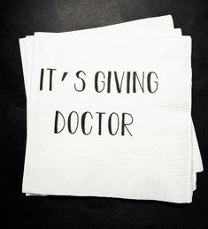 two napkins that say it's giving doctor