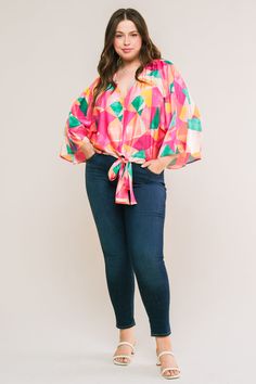 A printed woven top featuring V neckline, kimono sleeve and front tie detailDetails:Self: 97% Polyester 3% SpandexSize & Fit- Model is 5`8" And Wearing Size Small- Measurements Taken From Size Small- Approx. Length: 20" Chic V-neck Top With Bold Print, Vibrant Print V-neck Top For Brunch, Chic Fall Tops With Kimono Sleeves, Spring Stretch Tops With Tie Waist, V-neck Tops With Tie Sleeves For Brunch, V-neck Top With Tie Sleeves For Brunch, Multicolor Wrap Top For Fall, Chic V-neck Tops With Bold Print, Spring Printed Top With Kimono Sleeves