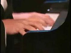 a person is playing the piano with their hands