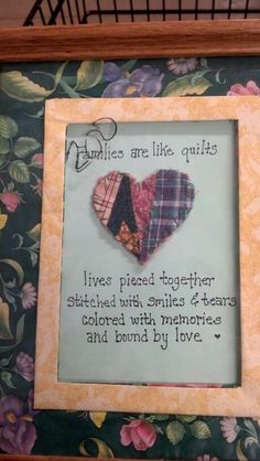 a picture frame with two hearts on it and a poem about quilts in the middle