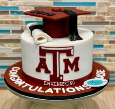 a cake that is decorated to look like a graduation cap and diploma on top of it