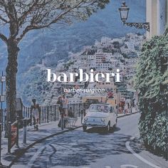 a car driving down a street next to a tall building with a sign that reads barbier