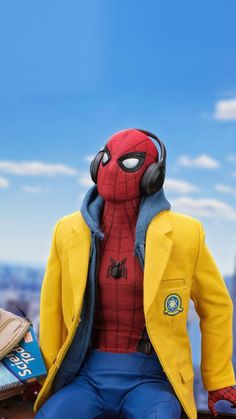 a spider - man with headphones sitting on top of a wooden table in front of a blue sky