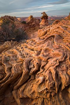 rock formations in the desert under a cloudy sky