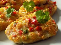 some food is on a white plate with green garnish and cilantro