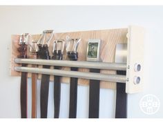 a wall mounted rack with many different types of knives and other things hanging on it