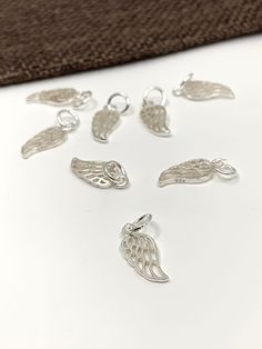 925 Sterling Silver Angel Wing Charm Approx. Size: 18mm x 6mm ( including jump ring) Approx. Inner Jump Ring: 4mm Color: Silver Material: 925 Sterling Silver Quantity: 1pc  Shipping Details: ♥ FREE SHIPPING to Canada via Canada Post for all orders above CA$100. Any orders above CA$50 will have a tracking number as well ♥ FREE SHIPPING to USA for all orders above US$35 via USPS First Class Mail Tracked. CA$8.99 Delivery charges for orders below US$35 ♥ All orders are shipped within 1-2 business d Elegant Sterling Silver Charms For Jewelry Making, Engraved Sterling Silver Charms In Silver, Sterling Silver Pendant Charm In Silver, Silver Sterling Silver Pendant Charm, Nickel-free White Gold Sterling Silver Charms, Sterling Silver Charms With Lobster Clasp, Sterling Silver White Gold Charms For Jewelry Making, White Gold Sterling Silver Charms For Jewelry Making, White Gold Sterling Silver Charms, Hallmarked