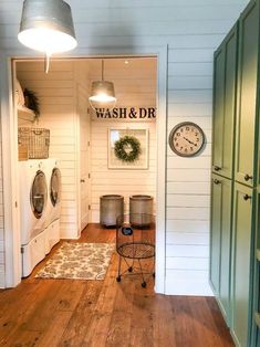 a washer and dryer in a room with wooden floors