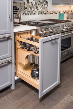 an open drawer in the middle of a kitchen