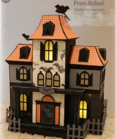 a halloween house with bats on the roof and windows, decorated in black and orange