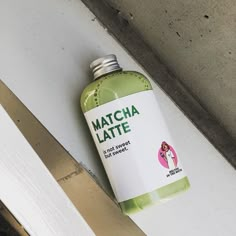 a bottle of matcha latte sitting on the floor