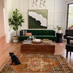 a living room filled with furniture and a dog sitting in front of a coffee table