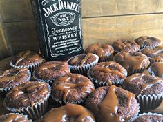 chocolate cupcakes with caramel drizzle on top and a bottle of jack daniels