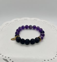 "Amethyst and Lava Bead Essential Oil Diffuser Bracelet made with 10mm gemstone and lava beads on sturdy stretch cord. Amethyst is an extremely powerful and protective stone with a high spiritual vibration. A natural tranquilizer, Amethyst blocks stress and negative environment energies. Amethyst has  strong healing and cleansing powers, and enhances spiritual awareness. Amethyst is extremely beneficial to the mind, calming or stimulating as appropriate. All diffuser bracelets come with a card briefly describing the gemstone's properties as well a a sample (about 10-15 drops) of our favorite essential oil blend to help you get started. Simply apply 1-2 drops of essential oil to the lava stone and allow to absorb. Breathe deeply and enjoy the benefits of aromatherapy on the go all day!  The Holistic Stretch Bracelet With 8mm Beads For Healing, Spiritual Lava Stone Stretch Bracelet Gift, Adjustable Purple Beaded Bracelets For Meditation, Everyday Spiritual Lava Stone Jewelry, Adjustable Lava Stone Stretch Bracelet Gift, Adjustable Lava Stone Bracelet For Meditation, Adjustable Lava Stone Stretch Bracelet For Meditation, Spiritual Purple Bracelets For Everyday, Purple Spiritual Bracelet For Everyday Wear