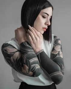 a woman with tattoos on her arms and arm