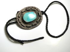 "Silver and Turquoise Bolo Tie Measures approx. 80.83 mm x 71.78 mm or 3-1/4\" x 2-3/4\" Stamped: \"Bennett Pat. Pend. C-31\" Total Weight: 116.5 Grams 81413-1924 FEEL FREE TO MESSAGE ME WITH A BEST OFFER OR IF YOU WISH TO SEE MORE PICTURES! We combine shipping where you pay only $1.00 more for any additional items on the same order! * Back to Shop Watch and Wares? https://www.etsy.com/shop/watchandwares * Ready to purchase? Click the green button \"Add to cart\" * Have a question? Click the but Turquoise Bolo Tie, Silversmith Jewellery, Navajo Bracelet, Bolo Ties, Navajo Turquoise, Heart Button, Bolo Tie, Fine Jewelry Collection, Tie Accessories