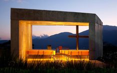 a couple of benches sitting under a cross