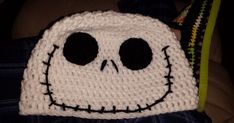 a crocheted skull hat with black eyes