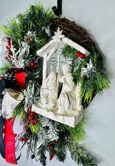 a christmas wreath with nativity scene on it