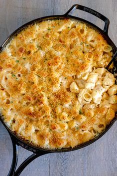 macaroni and cheese casserole in a cast iron skillet on a wooden table