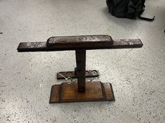 an old wooden bench sitting on top of a floor