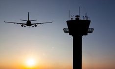 an airplane is flying in the sky at sunset or dawn, with another plane just above it