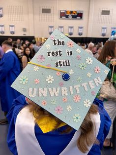 a person wearing a graduation cap that says the rest is still unwritten on it