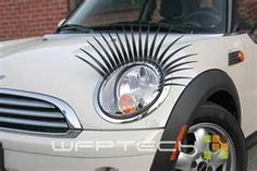 the front end of a white mini cooper