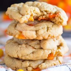 three cookies stacked on top of each other with candy in the middle and one cookie missing