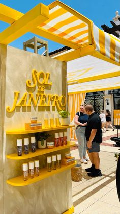 two men standing in front of a yellow and white sign that says soi de navero