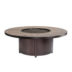 an outdoor fire pit sitting on top of a wooden table with gravel in the middle