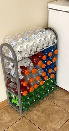 a stack of water bottles sitting on top of a metal rack next to a white refrigerator