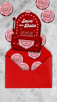 a red envelope with some pink and white buttons on it, sitting next to an envelope that says save the date