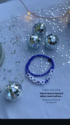 some disco balls and beads on a table