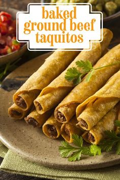 some taquitass are on a plate with salsa and other foods in the background