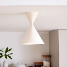 a white light hanging from the ceiling in a kitchen