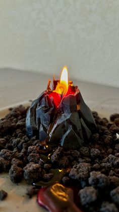 a lit candle sitting on top of chocolate chips