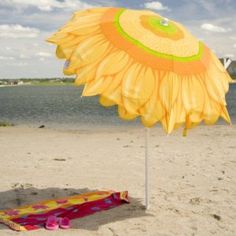 an umbrella on the beach near some water