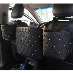 two bags in the back of a car with silver studded trims on them